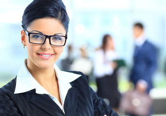 Wall Mural - business woman standing with her staff in background