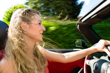 Young woman with cabriolet in summer on day trip