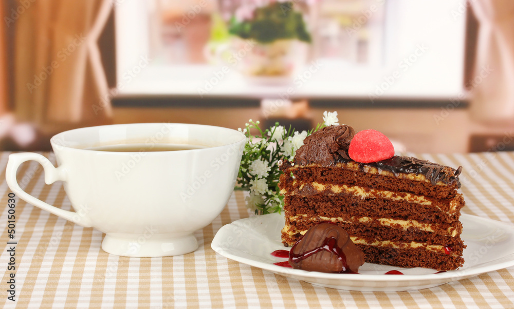 Cup of tea and delicious cake on window background