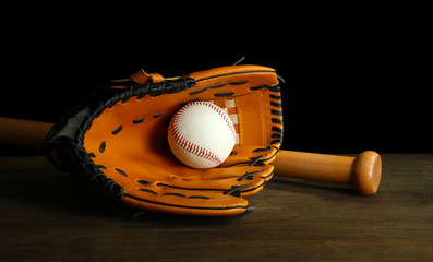 Canvas Print - Baseball glove, bat and ball on dark background