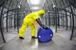 fully protected  technician,rolling a barrel wh toxic substance