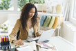© JGI/Tom Grill/Blend Images - Hispanic businesswoman sitting at desk using laptop
