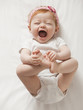 © Mike Kemp/Blend Images - Laughing Caucasian baby girl