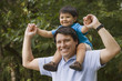 © REB Images/Blend Images - Hispanic father carrying son on shoulders