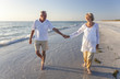 © Darren Baker - Happy Senior Couple Walking Holding Hands Tropical Beach