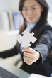 © JGI/Jamie Grill/Blend Images - Japanese businesswoman holding puzzle piece