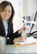 © JGI/Jamie Grill/Blend Images - Japanese businesswoman holding model wind turbine