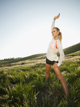 Caucasian Woman Stretching In Remote Field