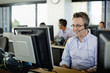 © Inti St Clair/Blend Images - Business people working on computers in call center