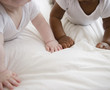 © JGI/Jamie Grill/Blend Images - Babies laying on floor together
