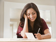 © Mike Kemp/Blend Images - Mixed race woman writing card
