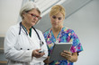 © Rick Gomez/Blend Images - Caucasian nurse and doctor using digital tablet