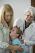© Rick Gomez/Blend Images - Crying girl having checkup in doctor's office