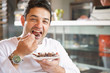 © GM Visuals/Blend Images - Hispanic man eating dessert in cafe