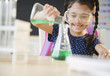 © JGI/Jamie Grill/Blend Images - Girl pouring liquid in chemistry class