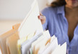 © JGI/Jamie Grill/Blend Images - Cape Verdean woman picking up file folder