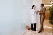 © Peathegee Inc/Blend Images - Doctor and businesswoman using digital tablet
