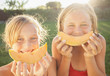 © Mike Kemp/Blend Images - Caucasian girls eating cantaloupe