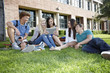 © Peathegee Inc/Blend Images - School friends hanging out on grass with digital tablet