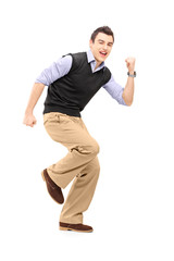 Canvas Print - Full length portrait of a young cheerful man gesturing happiness