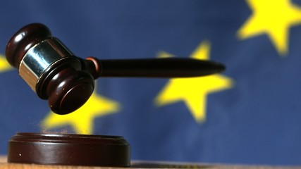 Wall Mural - Gavel falling with european union flag in background