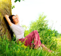 Wall Mural - beautiful young woman relaxing outdoors. nature