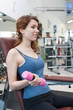 © pio3 - Young woman exercising with dumbbells in the gym.