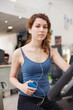 © pio3 - Young woman training in the gym with bike listening to music
