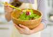 © Alliance - Closeup on fresh vegetable salad in hand of housewife