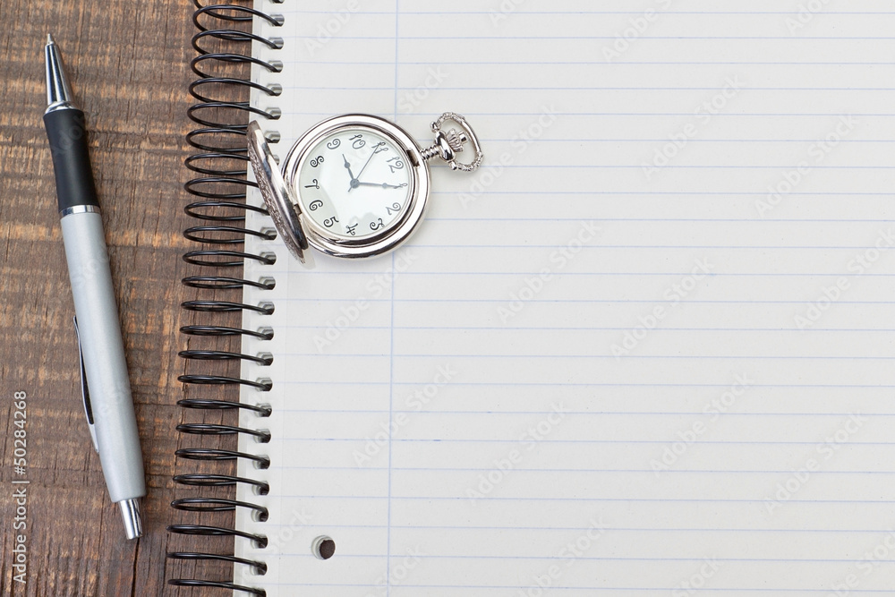 Antique pocket watch on notebook for notes. On textured wood. Stock ...