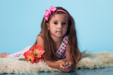 Wall Mural - cute little girl on blue background