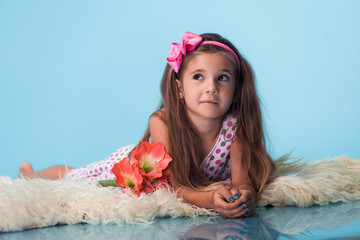 Wall Mural - cute little girl on blue background