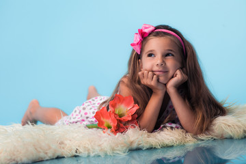 Wall Mural - cute little girl on blue background
