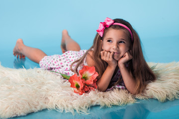 Wall Mural - cute little girl on blue background