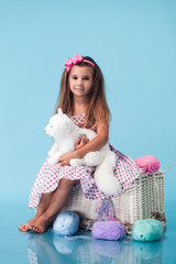 Wall Mural - cute little girl on blue background
