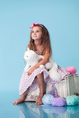 Wall Mural - cute little girl on blue background