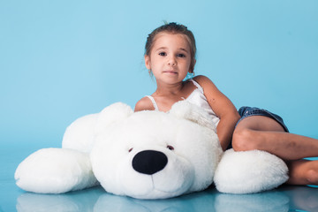 Wall Mural - cute little girl on blue background