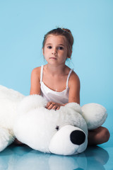 Wall Mural - cute little girl on blue background