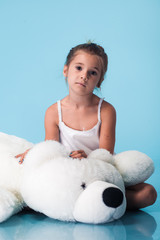 Wall Mural - cute little girl on blue background