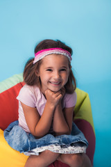 Wall Mural - cute little girl on blue background