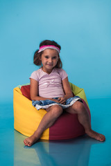 Wall Mural - cute little girl on blue background
