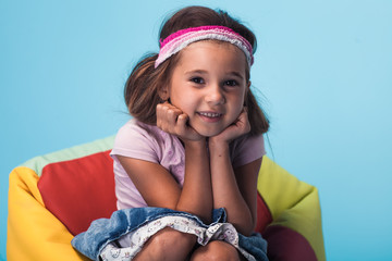 Wall Mural - cute little girl on blue background
