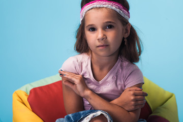 Wall Mural - cute little girl on blue background