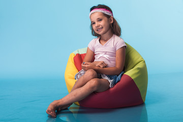 Wall Mural - cute little girl on blue background