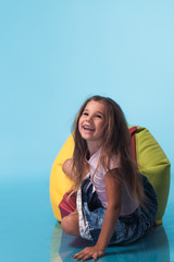 Wall Mural - cute little girl on blue background