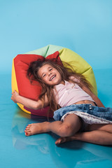 Wall Mural - cute little girl on blue background