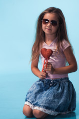 Wall Mural - cute little girl on blue background