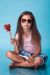 Wall Mural - cute little girl on blue background