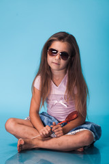 Wall Mural - cute little girl on blue background