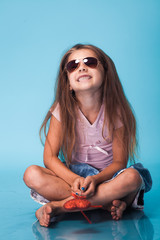 Wall Mural - cute little girl on blue background